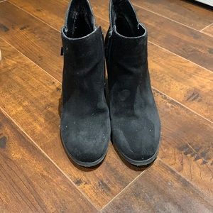 Black booties with gold zipper